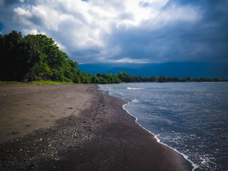 Natural Scenery Coastline Of Tropical Beach Village With Cumulus Clouds In The Afternoon, North Bali, Indonesia