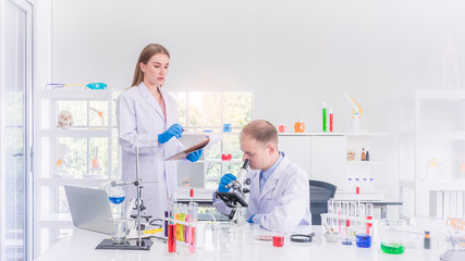 Two scientists working in chemical laboratory