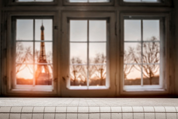 Wooden desk of free space for your decoration.Blurred retro old window with city landscape of Paris. Valentine's Day background and copy space. 