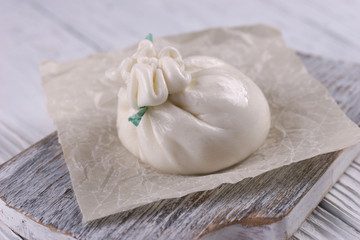 Burrata cheese bag on wooden background