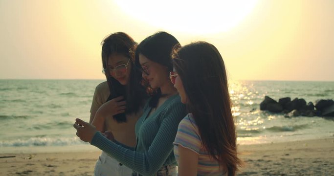 Group of women friends posing reaction taking photos at sea beach enjoy life smiling on weekend holidays, Attractive together of asian female traveler people lifestyle. 4K UHD Footage cinematic.