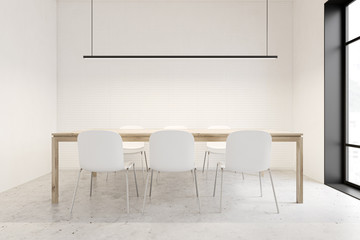 White dining room with wooden table