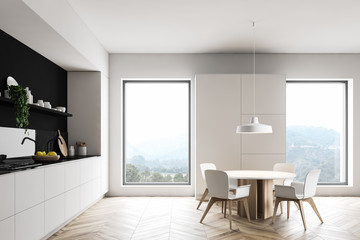 White kitchen interior with cupboard and table