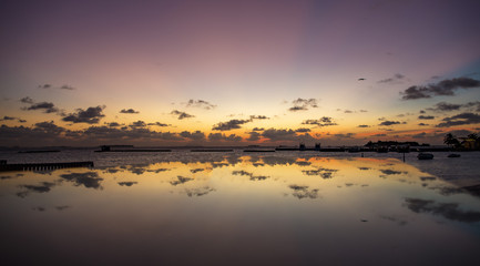 Obraz na płótnie Canvas reflection of a table on a resort beach at sunset