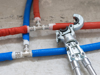 Plumbing copper pipe crimper press tube tool. Heating pipes connected by press fittings. Hydraulic,...