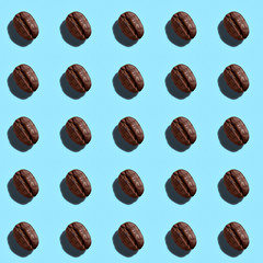 Color pattern of coffee beans on a blue background.  Top view.