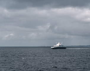 One of the car ferries between Mortavika and Arsvågen sailing in harsh sea, Norway