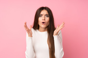 Young woman over isolated pink background with surprise facial expression