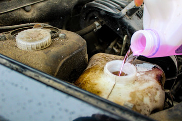 filling of non-freezing liquid in the glass washer tank in the car