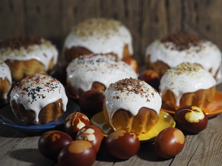 Easter. Cooking Easter cakes at home. Easter baking with natural sprinkles and colored eggs on a wooden ancient background.