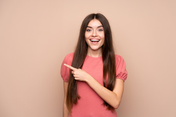 Young woman over isolated background pointing finger to the side