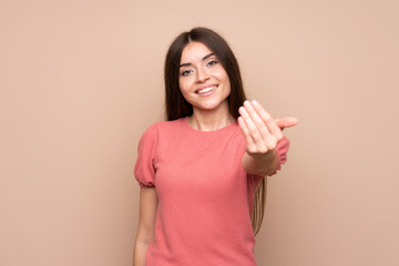 Young woman over isolated background inviting to come