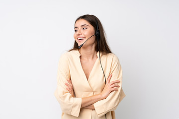 Young telemarketer woman over isolated white background laughing