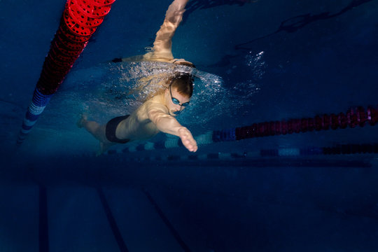 male athlete in a swimming competition swims in the pool. scuba diving, swimmer goggles for swimming and swimming