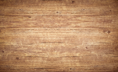 Wood texture background, top view of vintage brown table with cracks. Wooden board surface with...