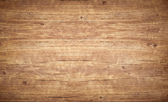 Wood texture background, top view of vintage brown table with cracks. Wooden board surface with natural color and pattern.