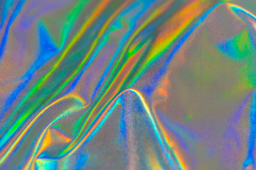 Iridescent fabric trendy holographic background. Rainbow background Colorful cloth chrome fabric.