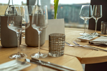A festively set table in a restaurant. Focus on the card with space for text. Concept: decoration or food and drink