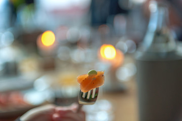 A bite of a delicious dish skewered on a fork. Concept: decoration or food and drink