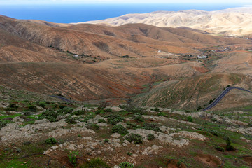 Panoramic view at landscape from viewpoint Mirador Morro Velosa on Fuerteventura with  green vegetation and multi colored volcanic hills
