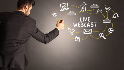 businessman drawing social media icons with LIVE WEBCAST inscription, new media concept