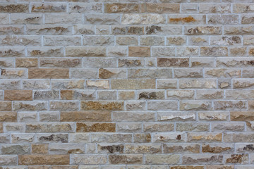The wall is made of facing stone. Background, texture.