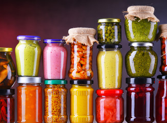 Jars with variety of pickled vegetables and fruits