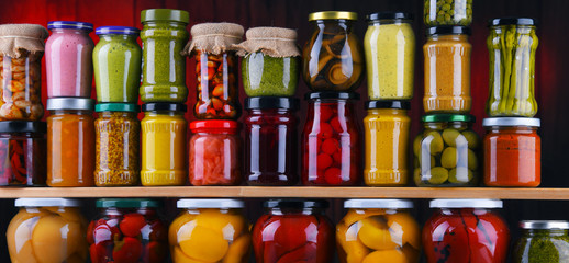 Jars with variety of pickled vegetables and fruits