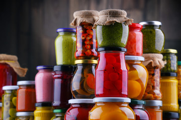 Jars with variety of pickled vegetables and fruits