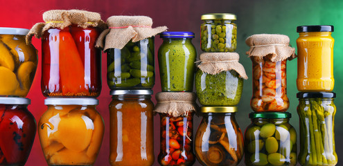 Jars with variety of pickled vegetables and fruits