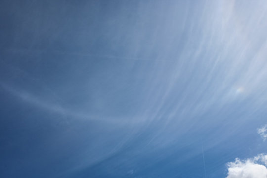 Atmospheric optical phenomena in the sky: part of the parhelic circle with mocksun (parhelium).