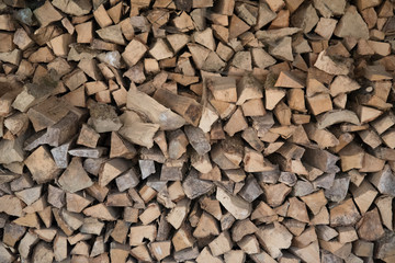 wall-mounted firewood, background of dry chopped wood, logs in a pile. Concept.