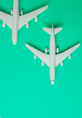 Fototapeta na wymiar Two jet airplane on pastel color background. Travel around the world.