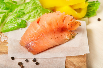 Piece of Salmon on wooden desk. Close up.