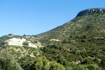 Fototapeta na wymiar Green mountain slope and blue sky