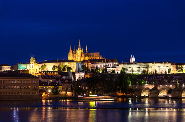 Fototapeta na wymiar View of Prague old town, historical center with Prague Castle, St. Vitus Cathedral in Hradcany district, Charles Bridge Karluv Most, Vltava river, night twilight evening view, Bohemia, Czech Republic