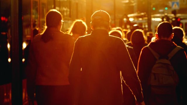 Crowd Of Pedestrians Walking To Their Work In The Morning. Beautiful Sunrise Backlight. 4K City Life Concept.