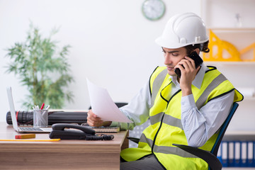 Young male architect working in the office