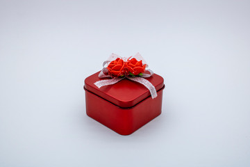 red gift box with ribbon and flowers
