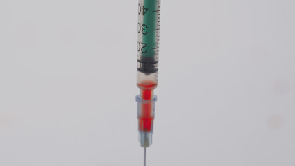 A doctor takes blood from a patient with suspected coronavirus 2019-nCoV