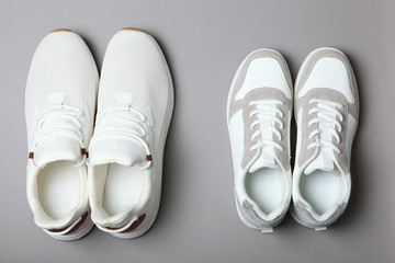 Men's and women's sneakers on a colored background top view. Sport shoes. White running shoes