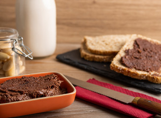 Homemade organic vegan chocolate spread, made of almonds and organic cacao and honey.
