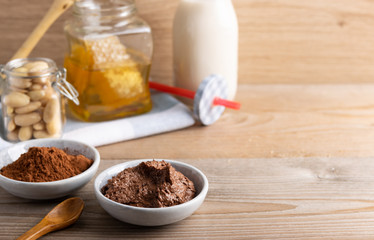 Homemade organic vegan chocolate spread, made of almonds, honey and cacao. With a jar of rice milk