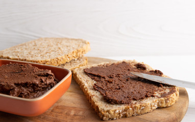 Homemade organic vegan chocolate spread, made of almonds and organic cacao and honey.