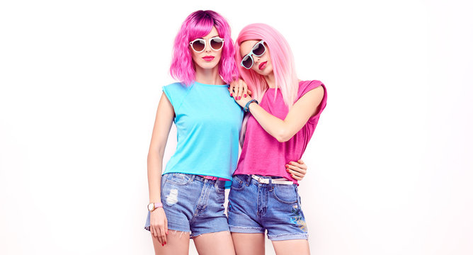 Fashion. Two Beautiful Hipster Woman, Stylish Clothes, Trendy Pink Hair. Cheerful Embracing Happy Model Girl, Sisters Friends On White. Creative Fashionable Lady, Trendy Pink Hairstyle Banner