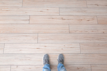 Person standing on floor, top view. Concept of choice