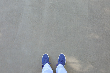 Person standing on asphalt road, top view. Concept of choice