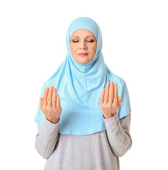 Muslim woman praying against white background