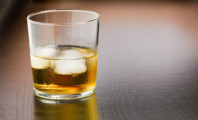 Close up of whiskey on wooden background and copy space