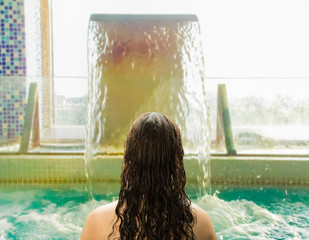 woman relaxing in the pool at a spa center